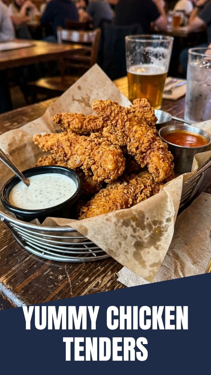 Golden brown crispy chicken tenders expertly fried and stacked.