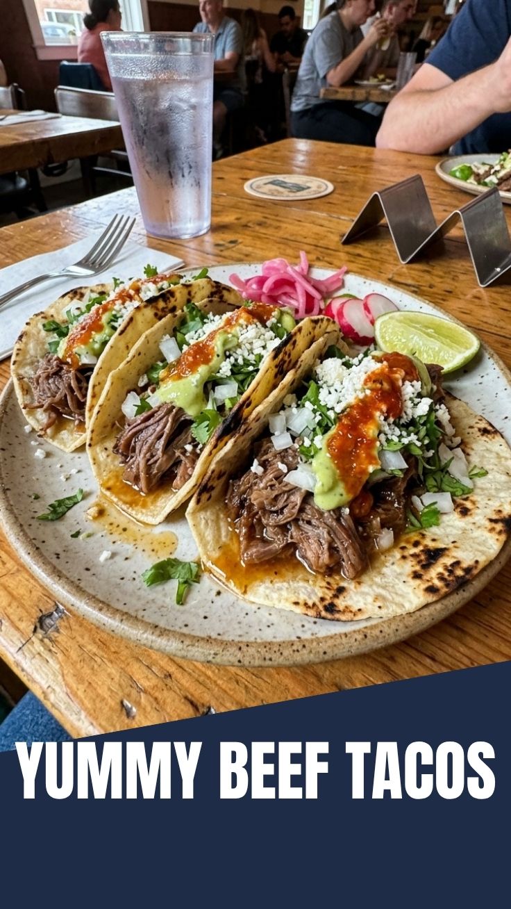Close-up of three delicious beef tacos with fresh toppings